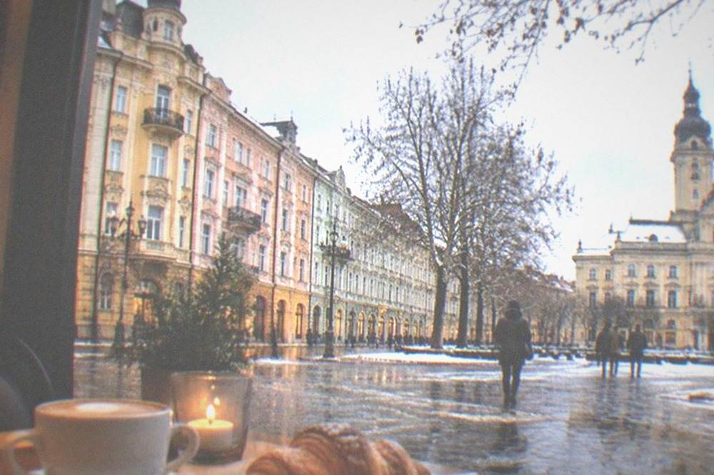 A warm cafe interior in the Timisoara old town with pastries and coffee on a table