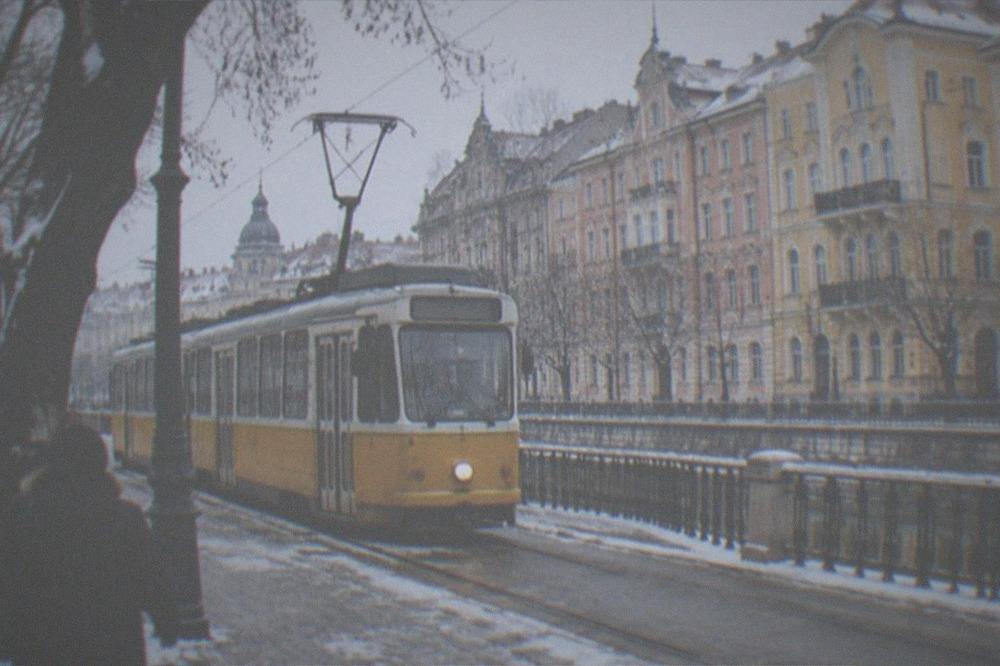 A tram passing decorated buildings on a cold clear day in Timisoara