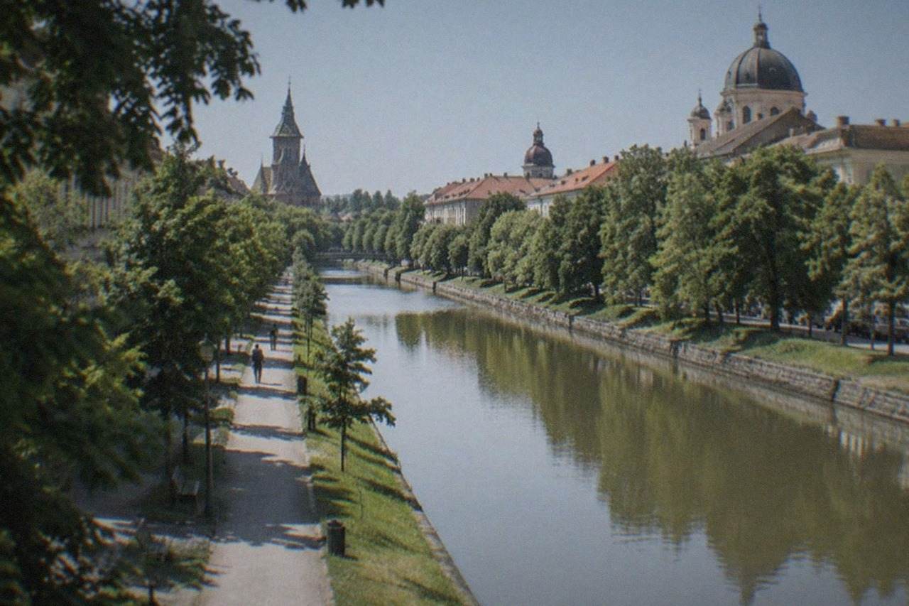 Aerial view over Timisoara's rooftops with church domes and the Bega canal running through the city
