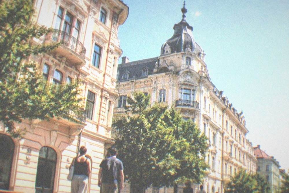 Visitors walking between museum buildings in the old town of Timisoara