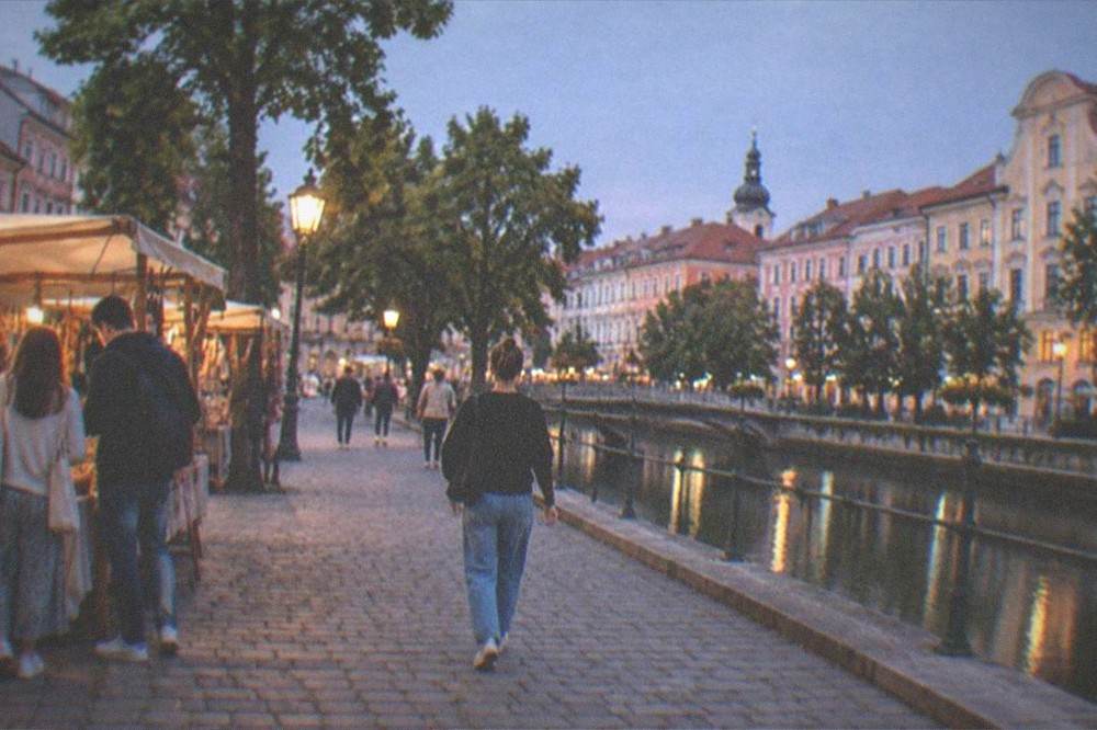 People browsing an outdoor stall with handcrafted goods in a Timisoara square