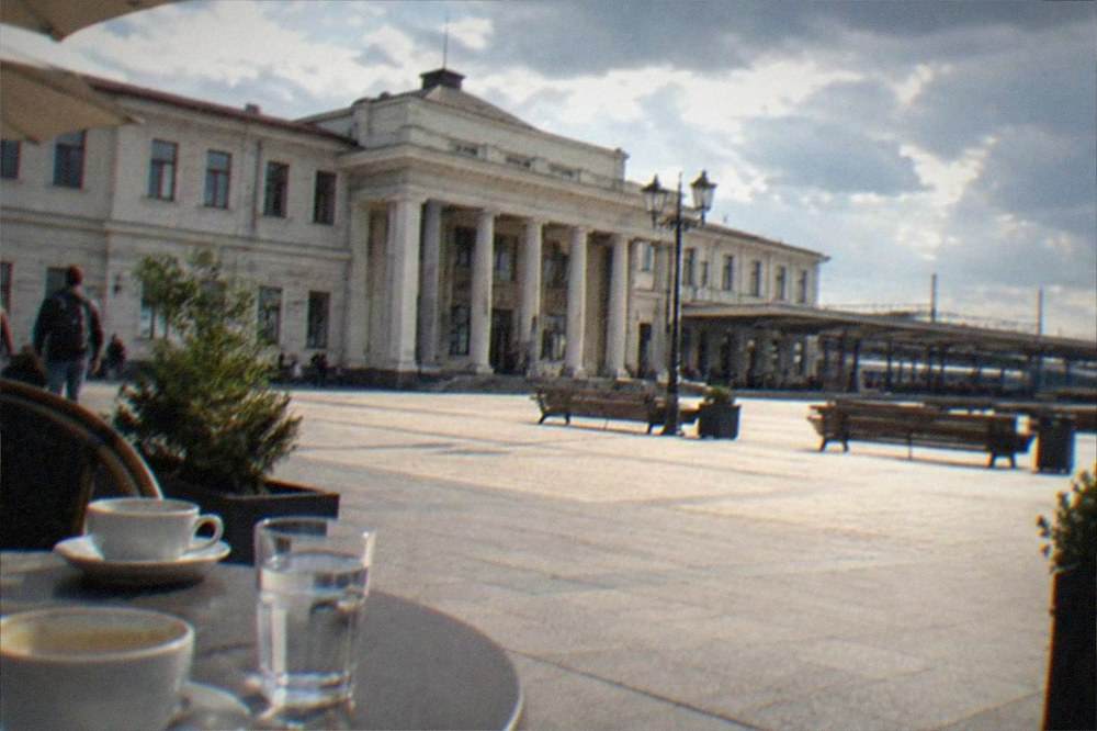 A cafe terrace with coffee cups on a table in a European square