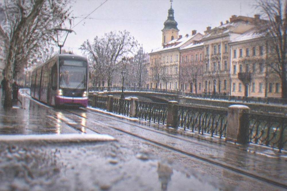 A modern tram on a Timisoara street under overcast winter skies