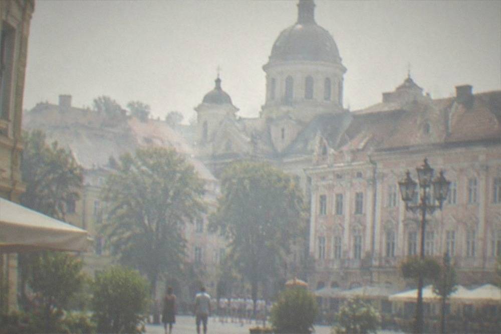 A historic market square with a church dome rising above rooftops