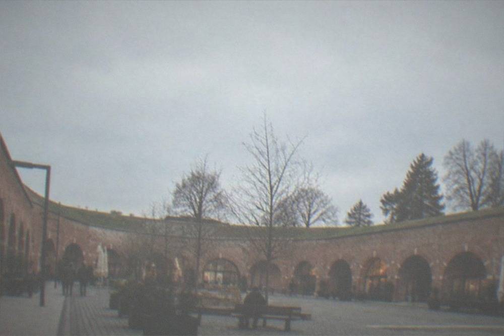 Red-brick bastion walls forming an arcade around a courtyard in the city center