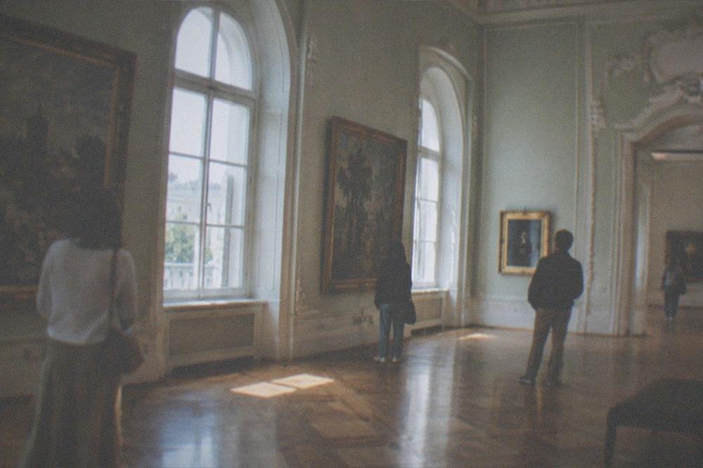 Visitors looking at paintings inside the Art Museum in the Baroque Palace in Timisoara